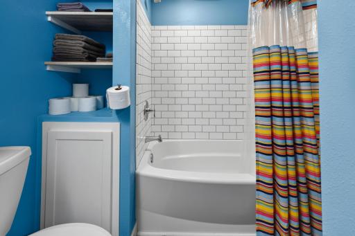 Lower Bathroom w/ Tiled Shower Surround