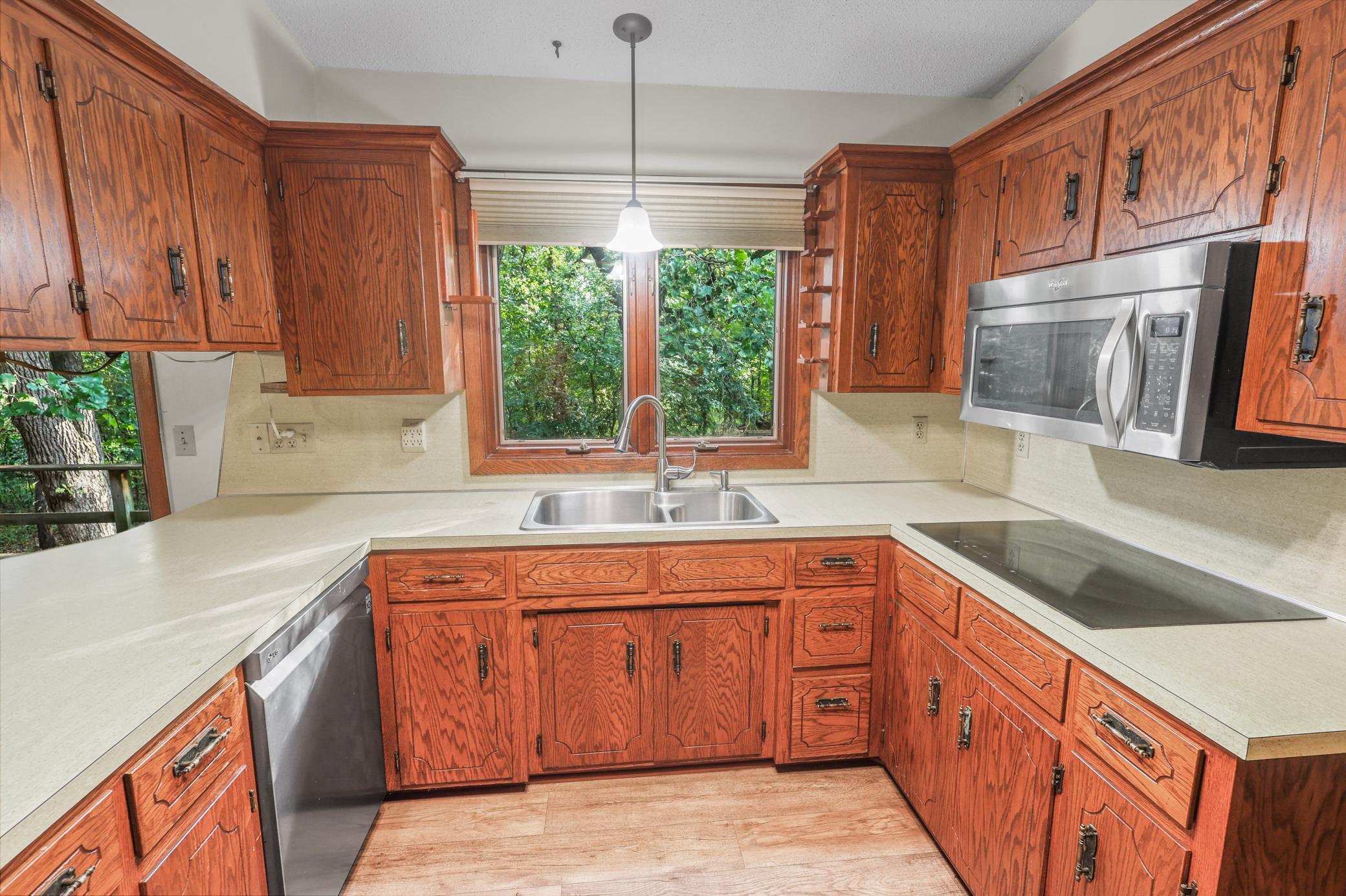 Kitchen features SS appliances and induction stovetop