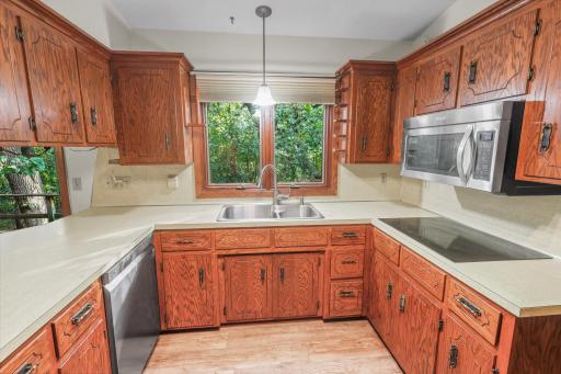 Kitchen features SS appliances and induction stovetop