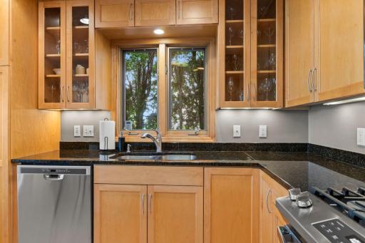 The custom cabinetry boasts glass front doors