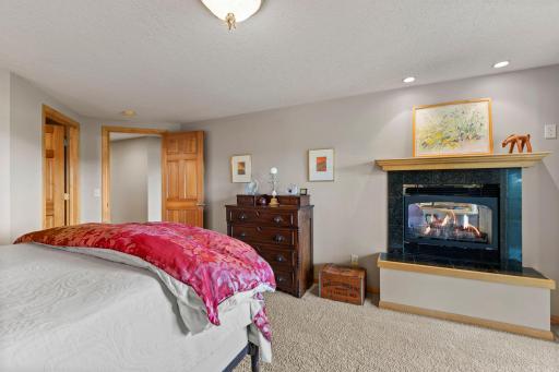 a luxury Bedroom suite with fireplace and glass door to the patio is on the lower level