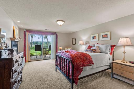 A luxury Bedroom suite with fireplace and glass door to the patio is on the lower level
