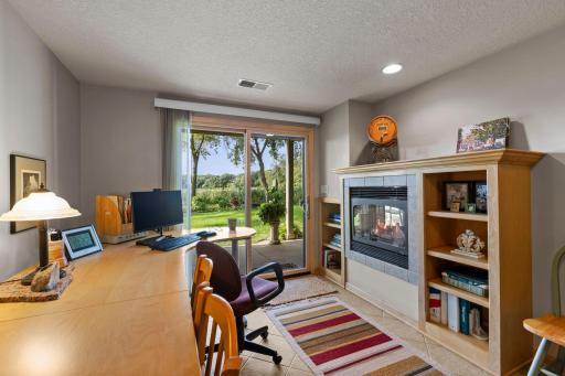 A Recreation Room with a fireplace and a glass door to the patio is on the lower level