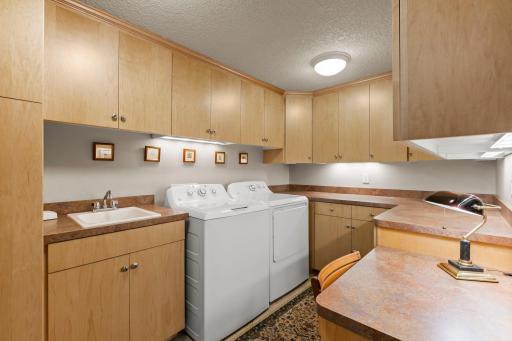 Check out this fabulous Laundry Room/Hobby Room with extensive cabinetry, counter-tops and lots of lighting!