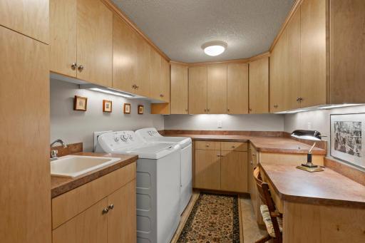 Check out this fabulous Laundry Room/Hobby Room with extensive cabinetry, counter-tops and lots of lighting!