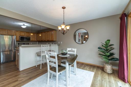 Dining room with updated LVP flooring and lots of natural light