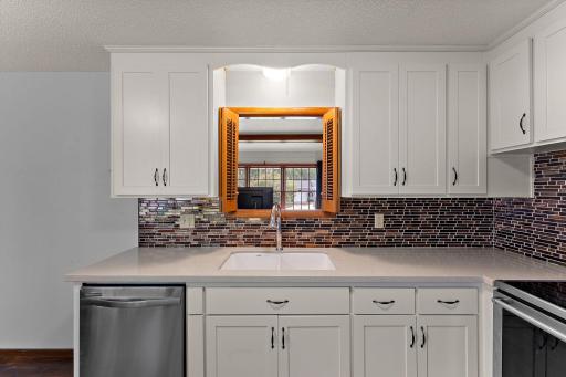 The pass through to the front living room is above the kitchen sink.