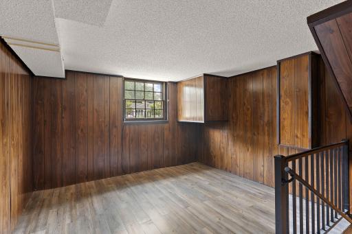 A view of the open bonus space on the second floor with the stairs leading to the basement first floor on the right.