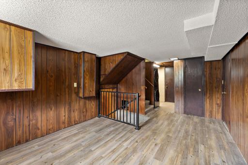 The second floor has the laundry area through the room beyond and features an ample bonus room with hard wood flooring. The 1/2 bathroom is located directly through the closed door across the room and garage access on the right.