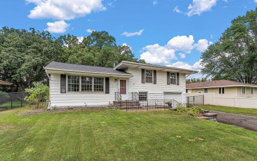 The front also features shutters and front paver steps and retaining wall leading up into this charming 4-level split home.