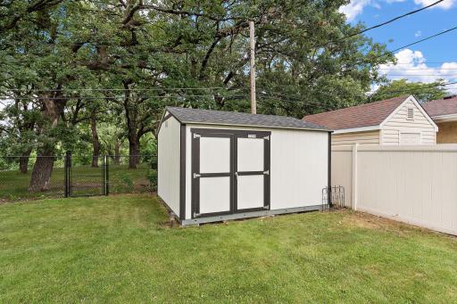 The small garden shed is useful for storing tools and note the gate for passing through the chain link fence to the other side for immediate access to the trails and park located just beyond the neighboring home.