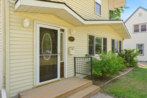 Welcoming front entrance features a maintenance-free composite porch, and a decorative glass storm door.