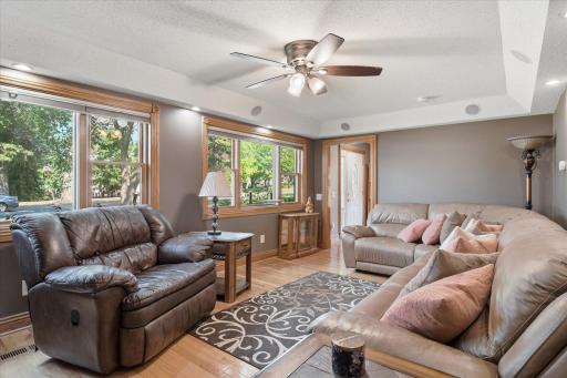 Thoughtfully designed this expansive living room features elegant woodwork, neutral finishes, recessed accent lighting, and plenty of space while the integrated surround sound system creates an exceptional home entertainment experience.