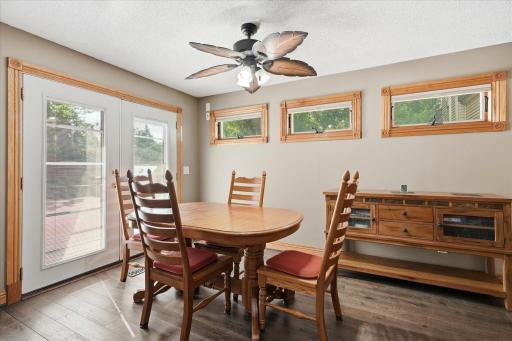 Bright dining space is enhanced by custom transom windows, while oversized double patio doors open directly to the impressive 40' x 38' private patio, creating a seamless indoor-outdoor entertaining experience.