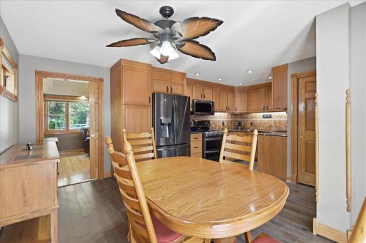 Open kitchen and dining area features luxury vinyl plank flooring, recessed lighting, newer stainless steel appliances, and abundant cabinet space, creating a functional layout that's perfect for everyday living and entertaining.