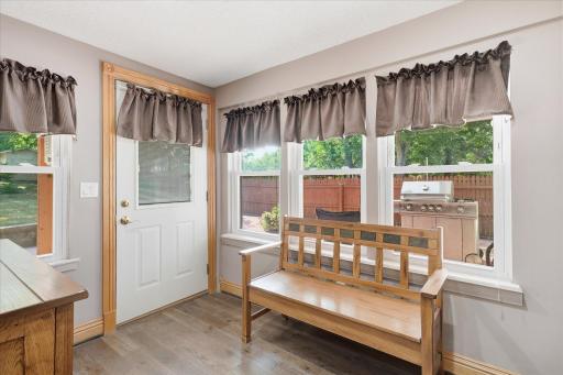 Large updated windows (2025) overlooking the private backyard and features direct access to the expansive 40' x 38' patio. This versatile space serves as the perfect drop zone.