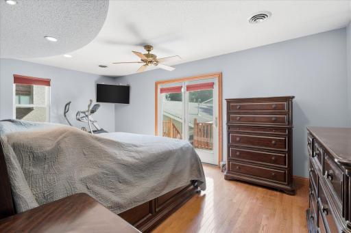 Wake up to abundant natural light in this inviting primary retreat featuring updated windows, and direct access to the private composite wraparound deck through a sliding glass door, creating the perfect indoor-outdoor escape.