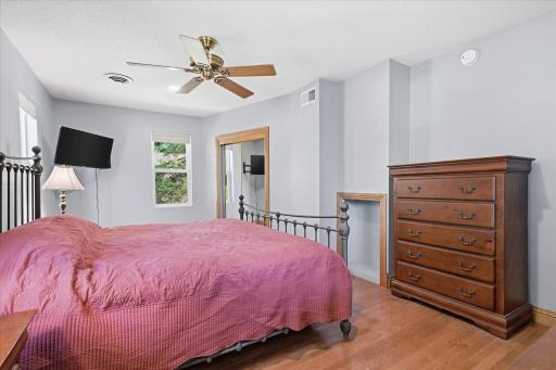 Another view highlights the bedroom's impressive size and flexible layout, offering ample space for larger furniture while the expansive closet provides abundant storage and organization.