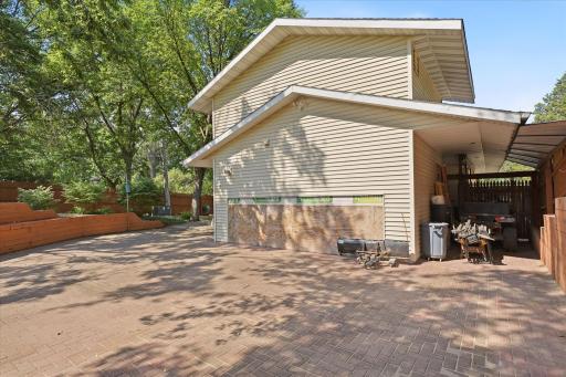Spacious paver courtyard style patio surrounds the detached studio, offering easy access to the additional covered storage 2nd carport.
