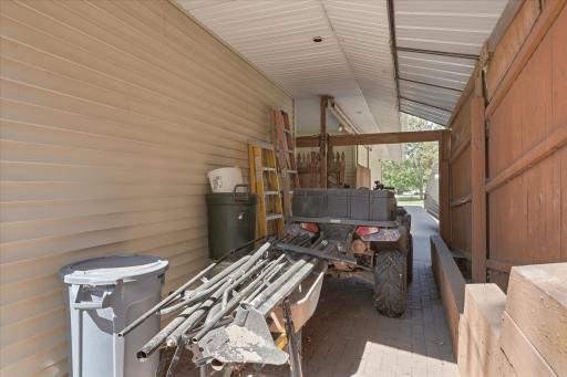 The 2nd 16x8 car port is fully fenced in with a barn door style entrance.