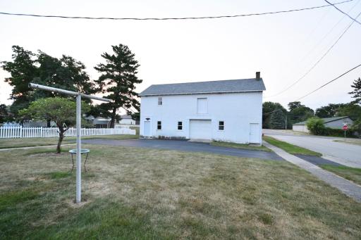 asphalt driveway with large 3 stall garage/loft