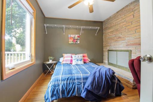 Bedroom 10 on the main floor near the rear entrance includes a ceiling fan, Bed, desk and dresser..jpg