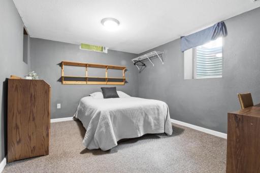 Room 9 Bed, Desk, chair, dresser and Egress window in lower level.jpg