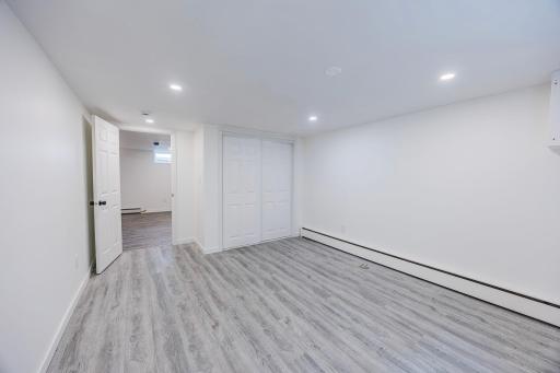 Newly finished third bedroom downstairs featuring a large egress window.