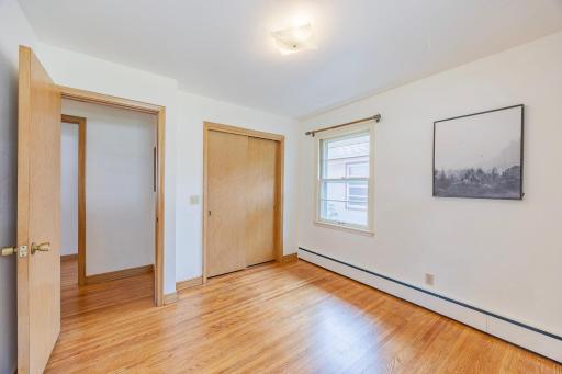 This second main-level bedroom is equally bright, pairing great natural light with beaming hardwood flooring.