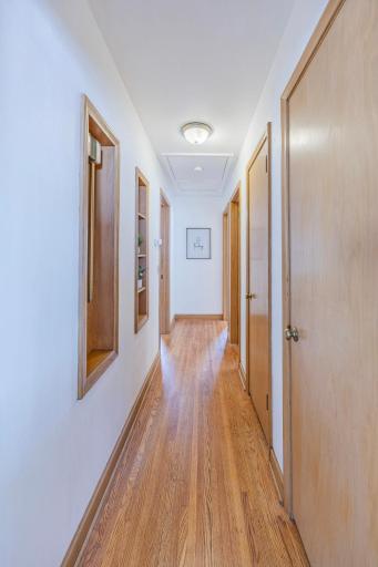 A pristine hallway highlighted by stunning original woodwork.