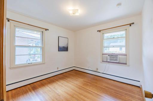 A different angle of the second bedroom showcases the newly installed window AC unit for optimal comfort.