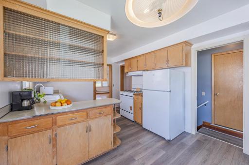 Original oak wood adds authentic retro warmth along with with the glass shelving creates an open, airy feel inside cabinets.
