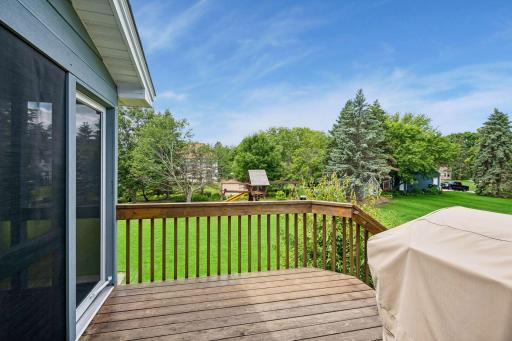 Deck off porch with steps to large backyard