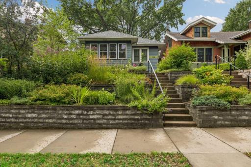 The home features lush landscaping.