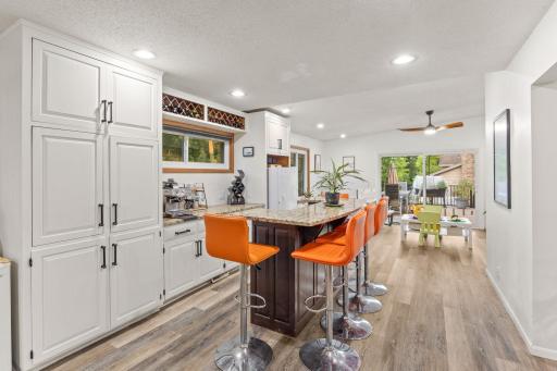 Further along the flex space opens to a custom wet bar area.