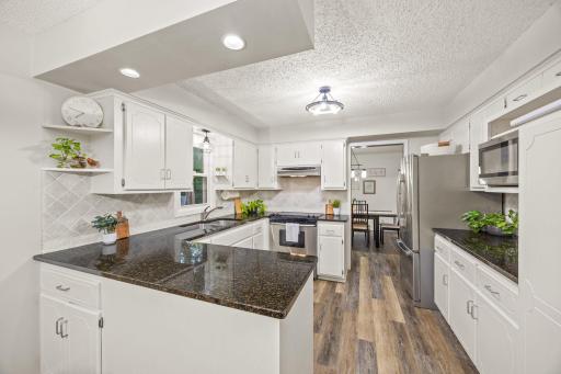 The kitchen offers ample cabinet space, a great area for a coffee nook and timeless updates.