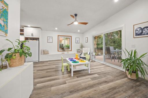 The flex room off the kitchen accesses the updated deck, offers built-in benches to enjoy for reading and storage and offers tons of options for a sitting room, game room, additional living or dining space, whatever you like.