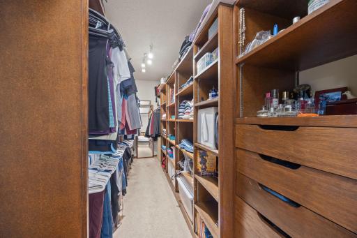 The walk-in closet with custom shelving will be your absolute delight.