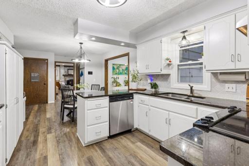 The dining room conveniently opens into the updated kitchen - the heart and center of the home.