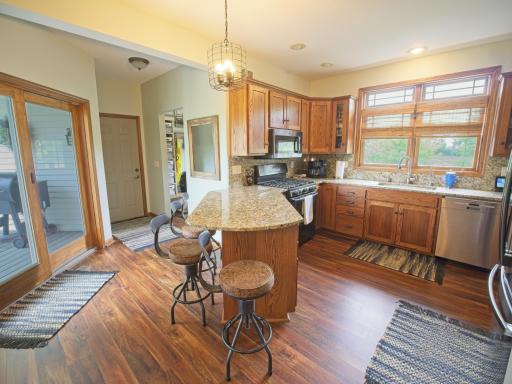 Another view of kitchen that shows the patio door and the access to garage.