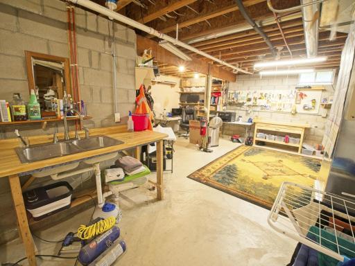 There is a "shop" area in the lower level that can serve as a home gym, hobby area, workshop...whatever you need! There is access to the garage from here!