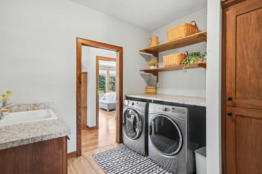 The convenient laundry room is located off the living room with a pocket door and connects to the back mud room and entry into the 3 car garage. There is a utility sink, built-in cabinets and a huge walk-in closet in this room.