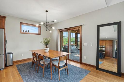 The informal dining room has ample space for entertaining and has a new modern light fixture and access to the sunroom through the sliding glass door.