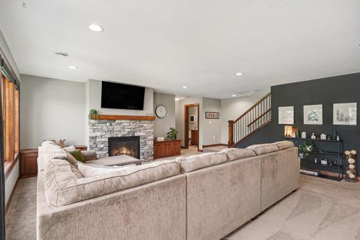 Built-in storage benches adorn each side of the stone stacked gas fireplace.