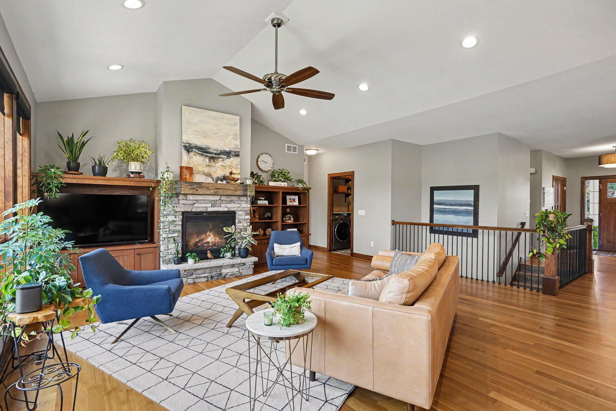 The vaulted living room welcomes you from the foyer, just past the open stairway to the lower level.