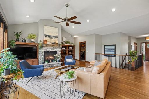 The vaulted living room welcomes you from the foyer, just past the open stairway to the lower level.