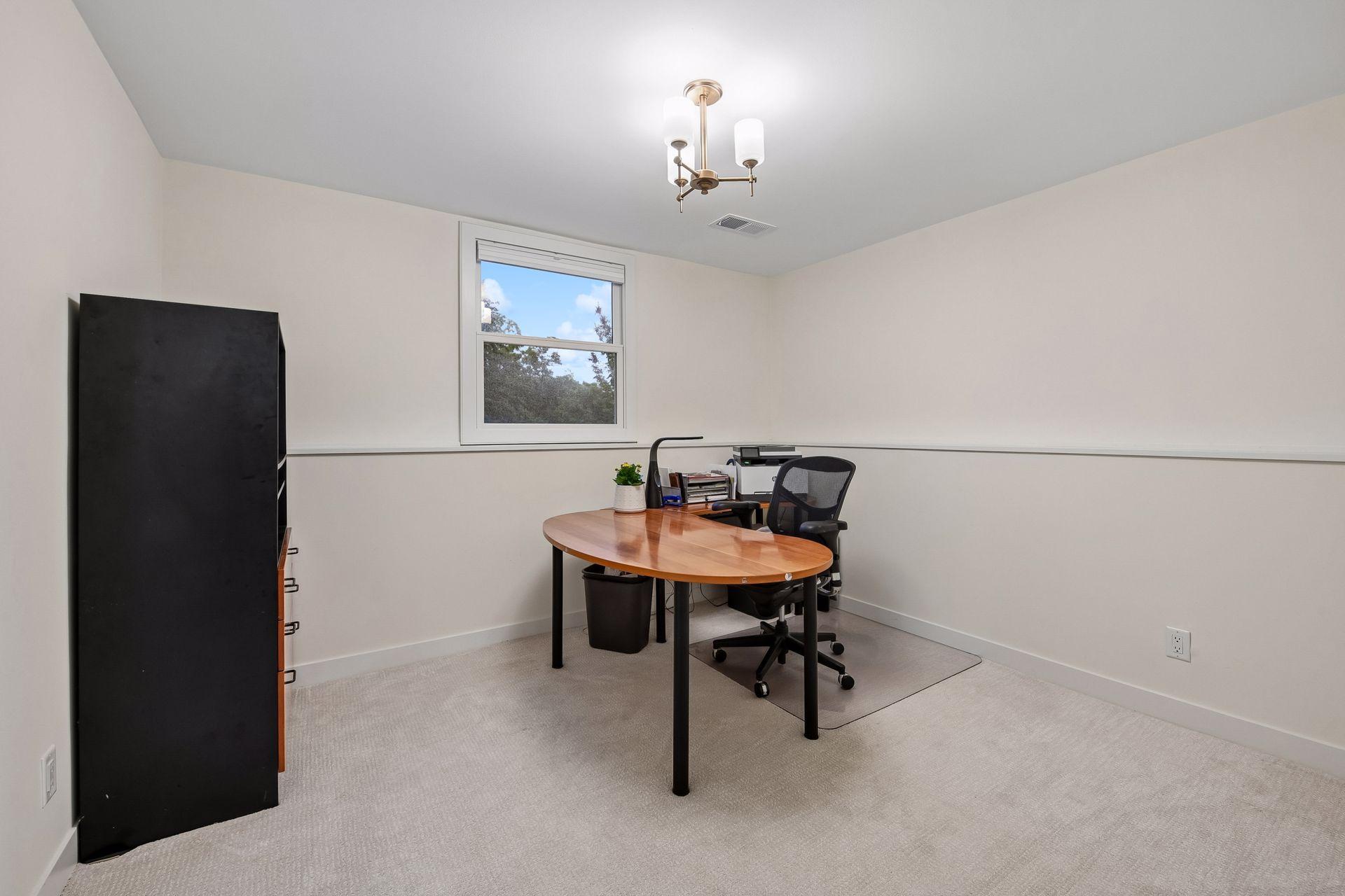 Versatile lower-level room offers ideal space for a home office