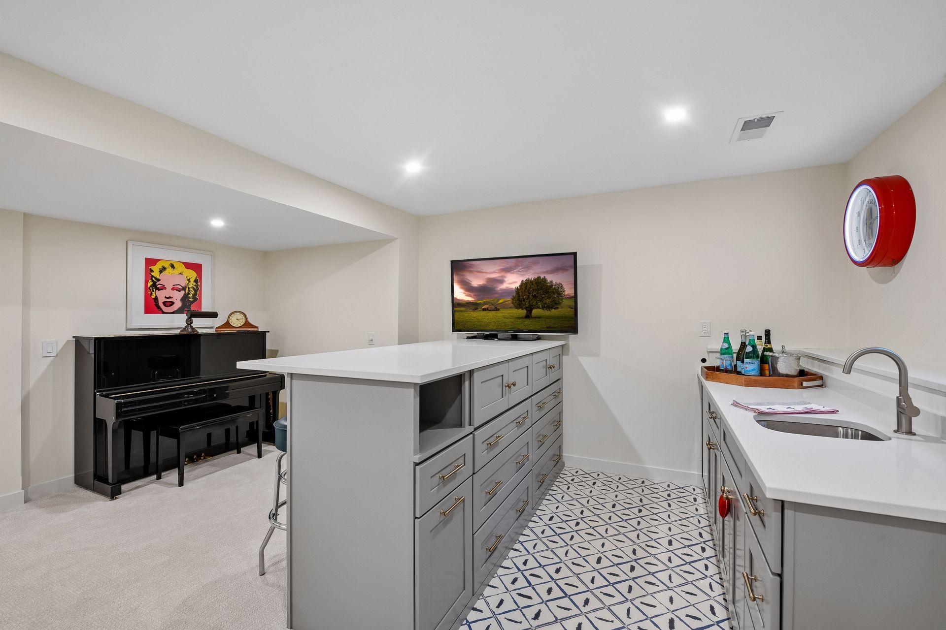 Custom wet bar features cabinetry, quartz countertops, and beverage storage