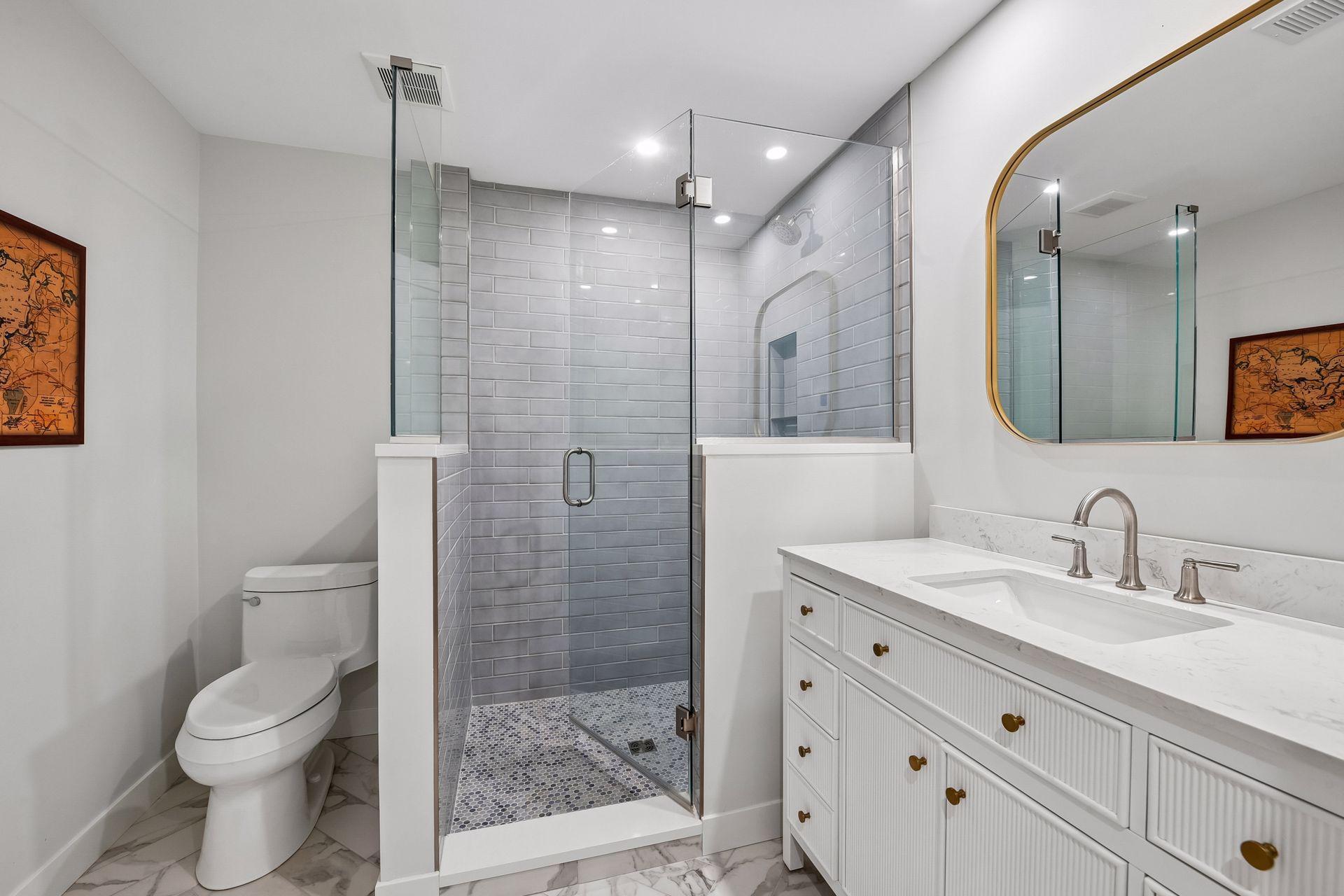 Updated bathroom features a tiled shower and elegant vanity