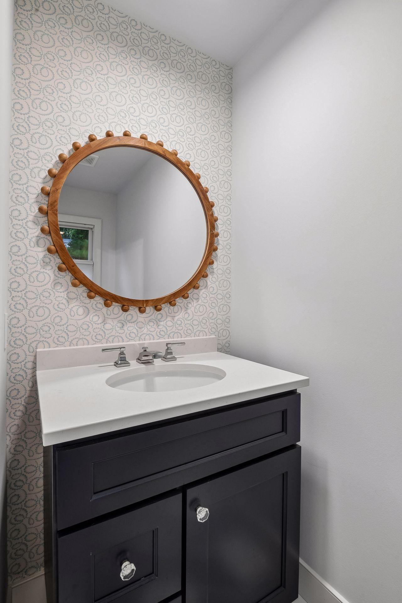 Updated vanity and designer finishes create a polished powder room